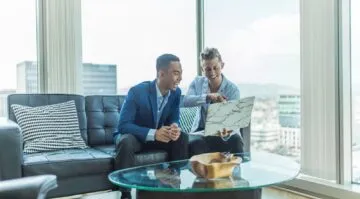 Two advisers reviewing an investment portfolio in a city office