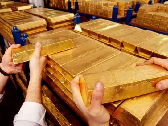 Cast gold bars being inspected in a bullion vault